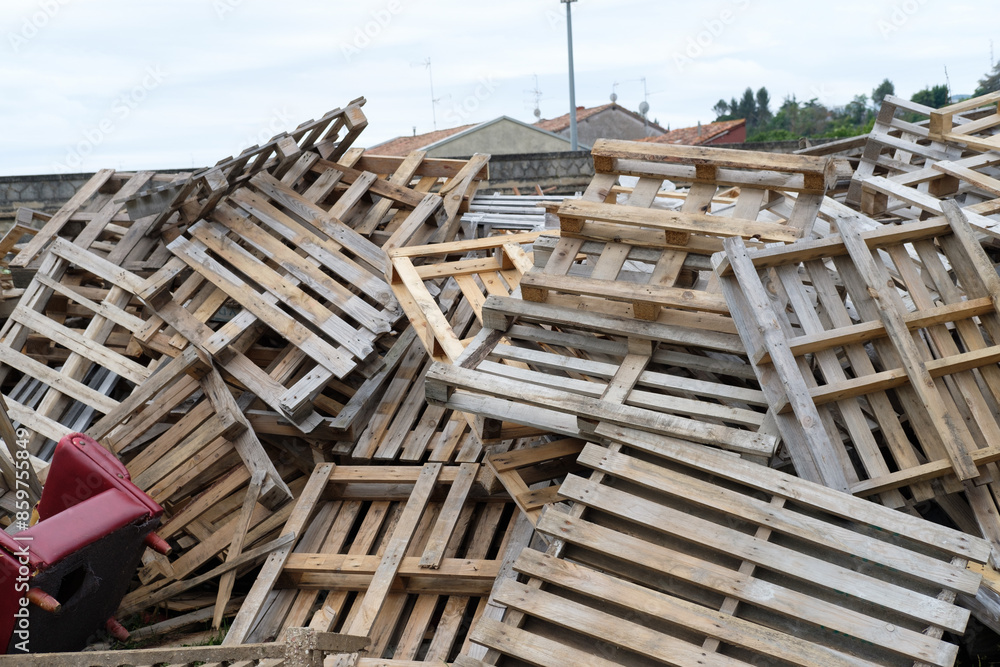 In the image, there is a pile of construction pallets and household items, arranged for burning in the San Juan bonfires. In the image, there is a pile of construction pallets and household items, arranged for burning in the San Juan bonfires.