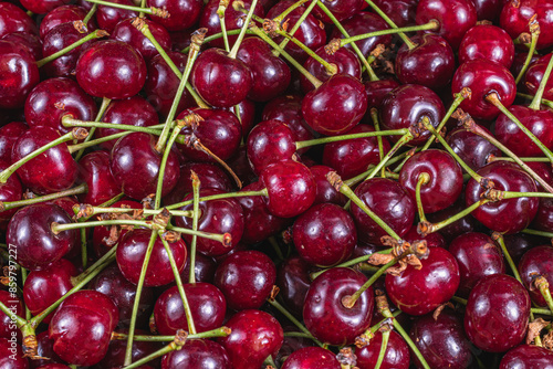 Ripe cherry in a plastic box on the table top view and side background