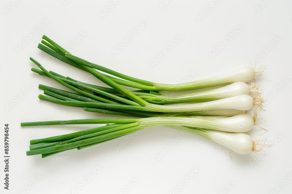 A cluster of scallions and fresh chives set against a white backdrop A cluster of scallions and fresh chives set against a white backdrop