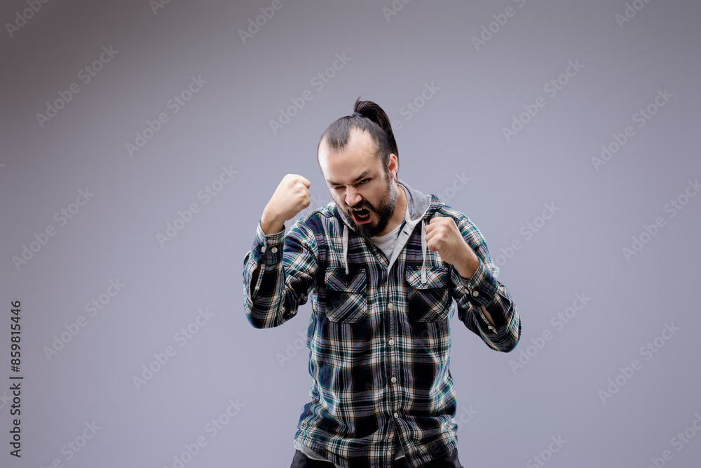 Bearded man with clenched fists expressing anger and frustration Bearded man with clenched fists expressing anger and frustration