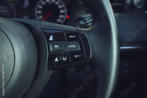 interior view of car with black leather, steering wheel with button photo