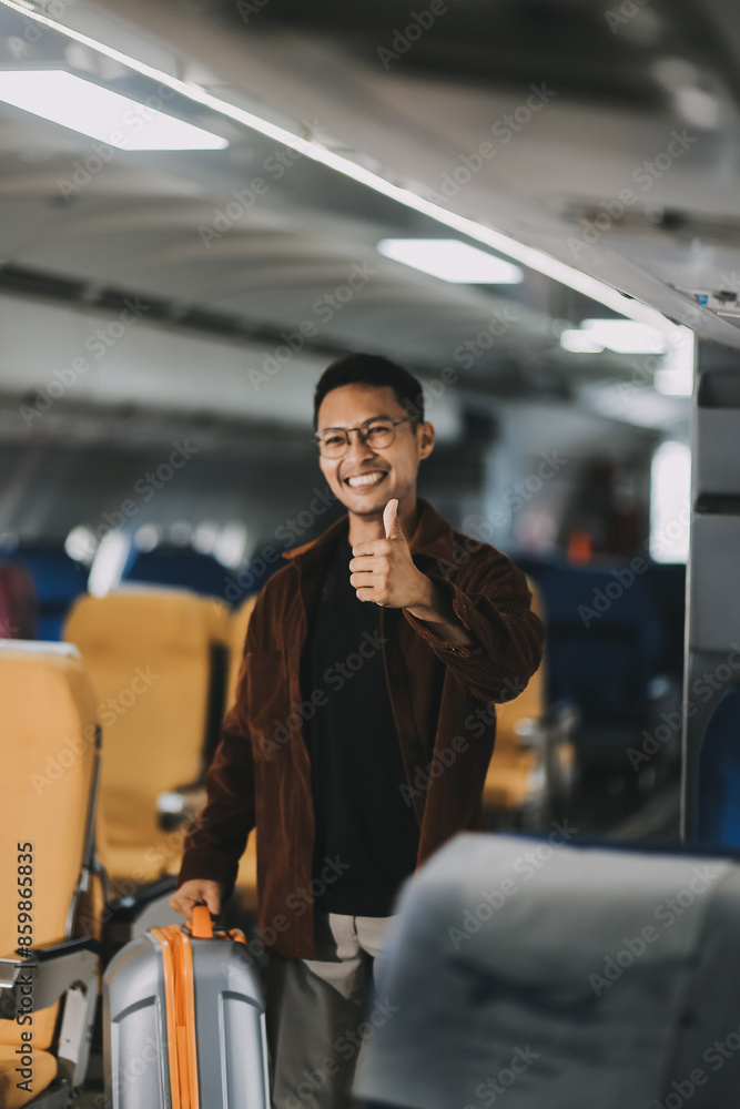 Low Section of Passenger Businessman Walking with Suitcase at the Entrance Walkway in Airport. Focus on Luggage. Low Angle View Low Section of Passenger Businessman Walking with Suitcase at the Entrance Walkway in Airport. Focus on Luggage. Low Angle View