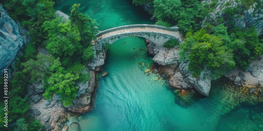 Obraz premium Stone Arch Bridge Over Turquoise River