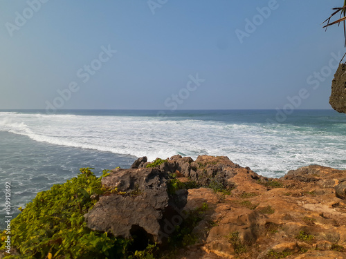 Ngandong Beach Splendor: A Serene Hillside Embracing the Azure Ocean photo