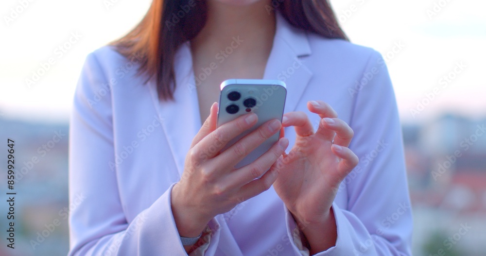 Fototapeta premium No face woman using smartphone. Phone in hands highlighting technology and modern lifestyle. Sense of connectivity, efficiency, and adaptability humans in the digital era. 