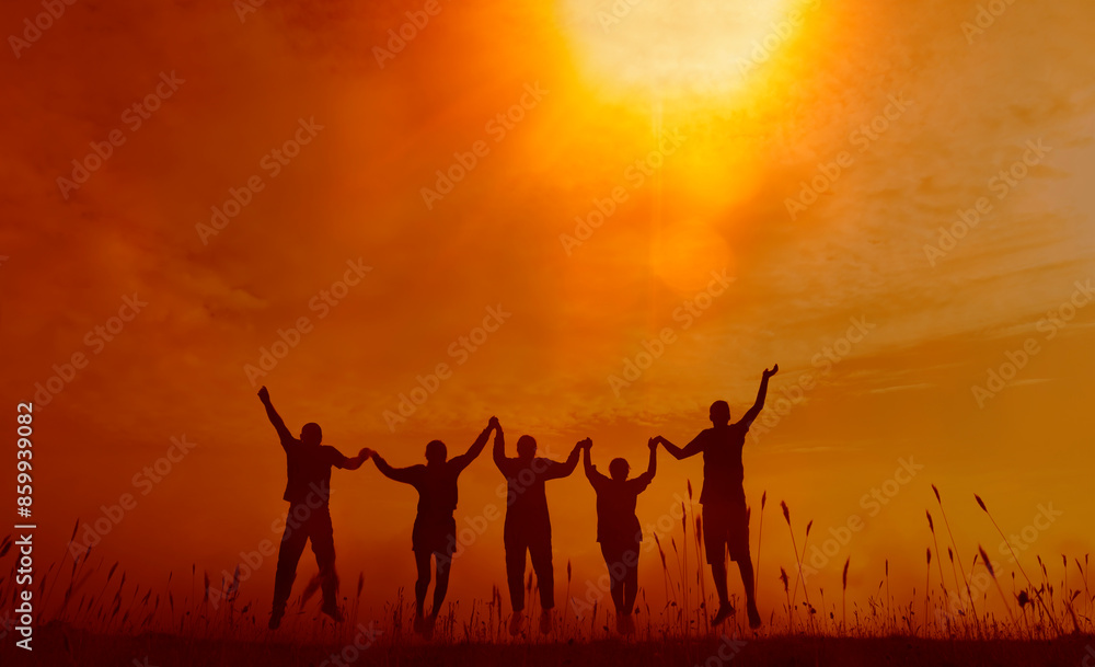 silhouette group of happy people against a stunning sunset on grass meadow, holding hands and jumping together. Success of teamwork collaboration and freedom sunset background. business concept sunray silhouette group of happy people against a stunning sunset on grass meadow, holding hands and jumping together. Success of teamwork collaboration and freedom sunset background. business concept sunray