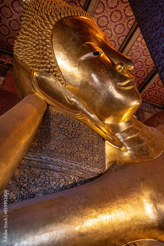 A large Reclining Buddha is one landmark of Wat Phra Chettuphon Wimon Mangkhalaram Ratchaworamahawihan in Bangkok, Thailand. A place everyone in every religion can visit. photo