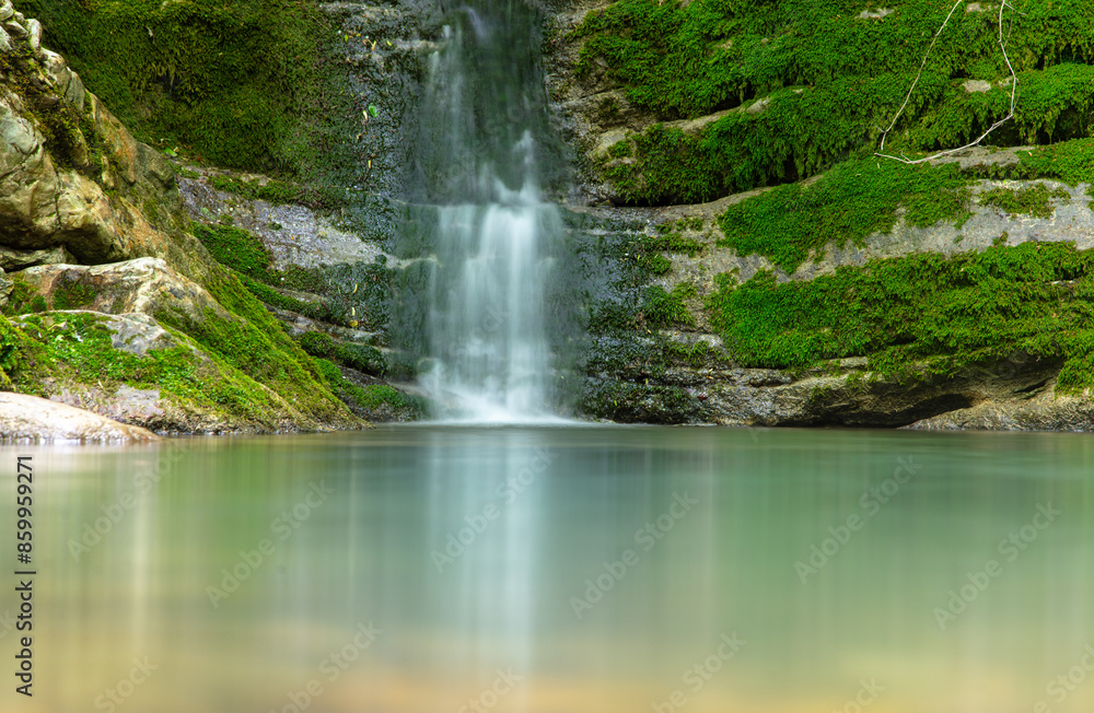 Naklejka premium Beautiful waterfall in the forest in the park