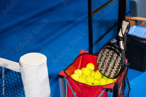 Paddle ball on racket. Yellow paddle ball laying near racket,  photo