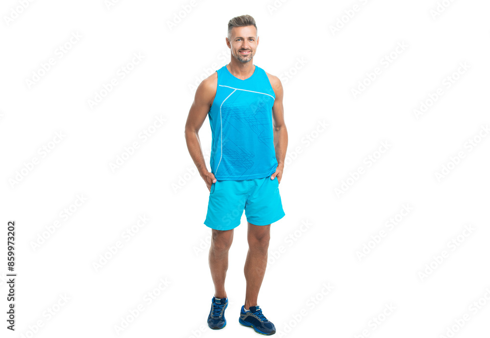 The male sport athlete posing on studio. sport athlete with fit body isolated against white. Sport and healthy lifestyle. full length of athlete. cheerful athlete wearing sport wear standing alone The male sport athlete posing on studio. sport athlete with fit body isolated against white. Sport and healthy lifestyle. full length of athlete. cheerful athlete wearing sport wear standing alone