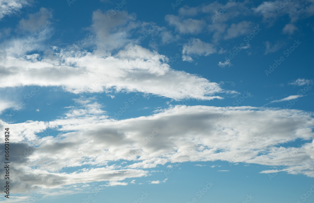Nature, sunshine and clouds in blue sky with warm climate, texture and meteorology on horizon. Heaven, spiritual air and summer weather with environment, cloudscape and natural skyline in morning Nature, sunshine and clouds in blue sky with warm climate, texture and meteorology on horizon. Heaven, spiritual air and summer weather with environment, cloudscape and natural skyline in morning