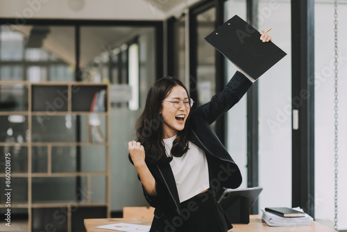 Quadro su tela Portrait of smile beautiful business asian woman suit working office desk computer