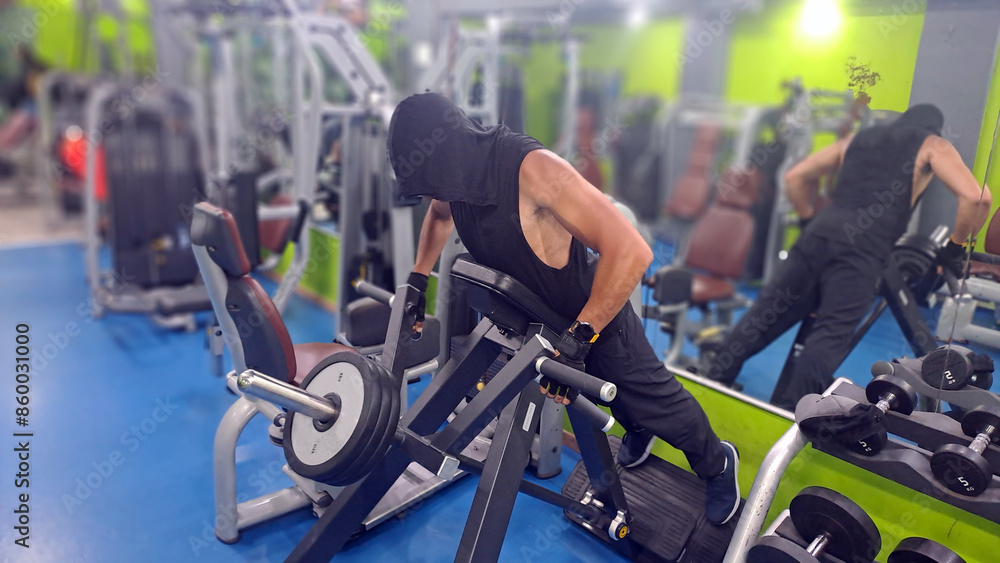Bodybuilder doing t-bar row exercise in the gym Bodybuilder doing t-bar row exercise in the gym