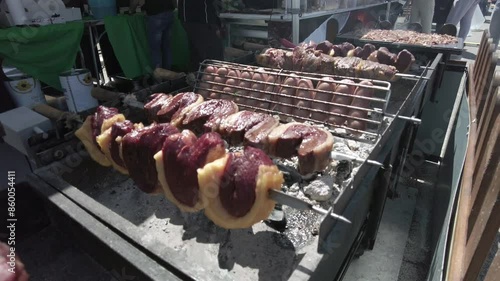 Pov view of delicious various kind of rolling grilled meat steaks cook on a street food stall