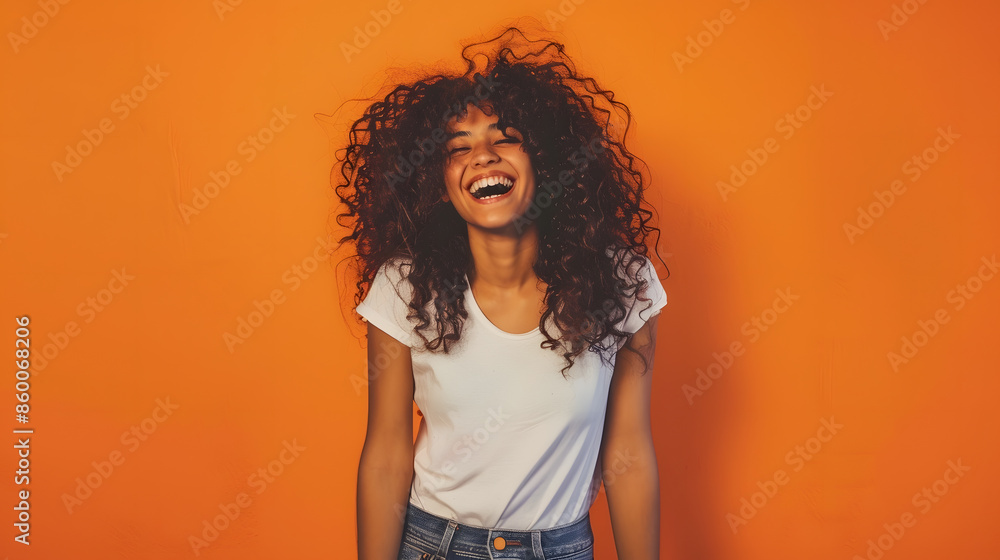 Laughing young woman with curly hair standing with her hands in her jeans pockets against an orange background : Generative AI Laughing young woman with curly hair standing with her hands in her jeans pockets against an orange background : Generative AI