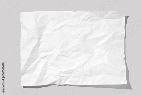 Crumpled piece of white parchment or baking paper on grey background. Top view. Copy space for text and design element.