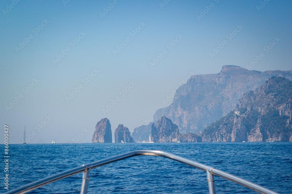 Sailing to famous Faraglioni rocks in Capri island, Italy.