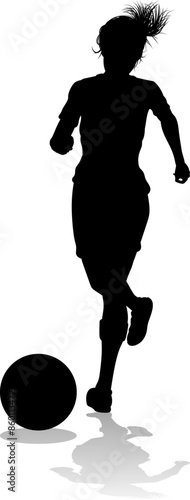 A female soccer football player woman in silhouettes
