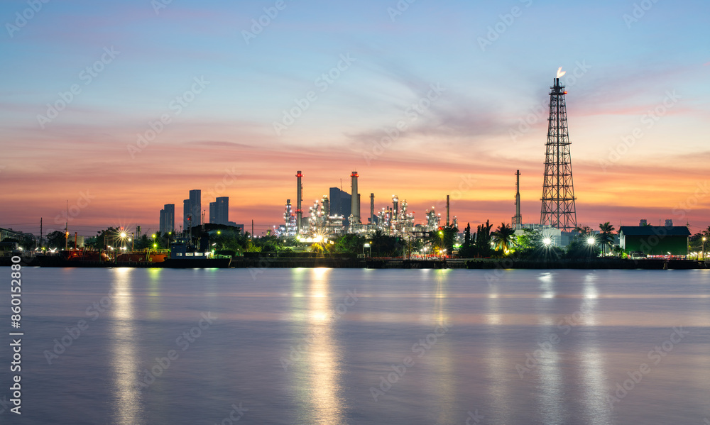 Naklejka premium Oil refinery plant industry and port, Aerial view oil and gas petrochemical industrial, Refinery factory oil storage tank and pipeline steel at night, Ecosystem and healthy environment concepts.