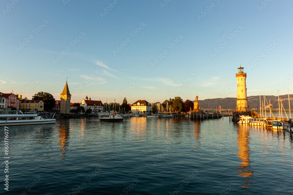 The harbor of Lindau at the Lake Constance with lighthouse and statue of bavarian lion. Germany The harbor of Lindau at the Lake Constance with lighthouse and statue of bavarian lion. Germany