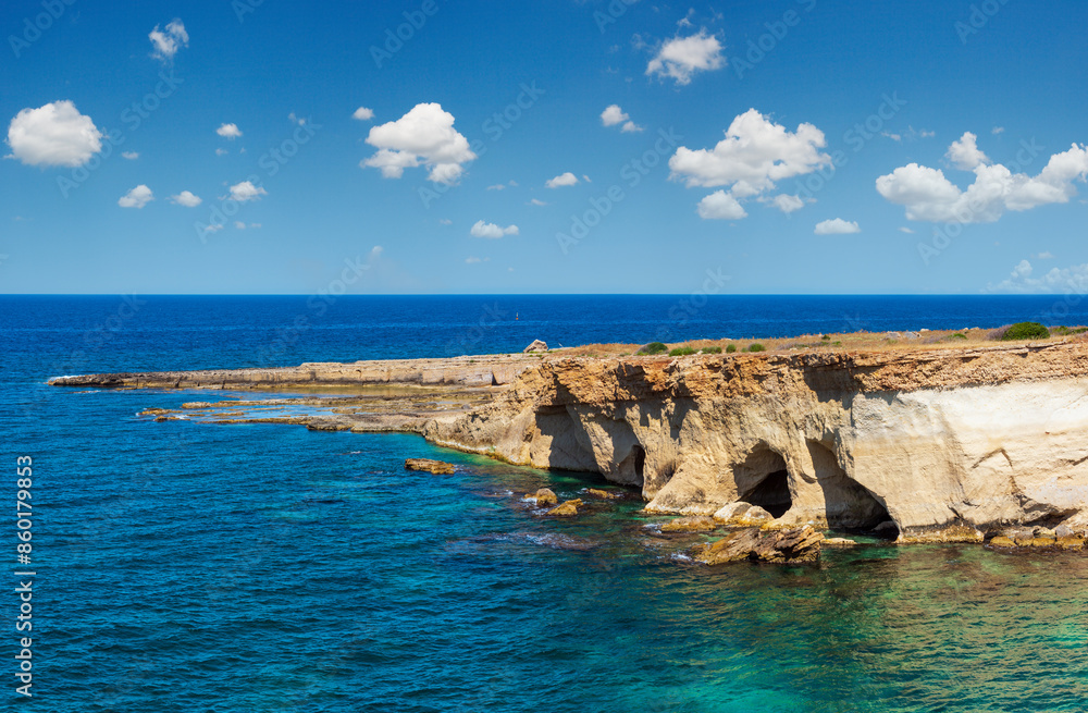 Grottoes on Spiaggia Massolivieri beach. Summer sea landscape (Siracusa, Sicily, Italy)