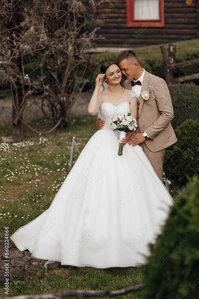 A bride and groom are standing in a field, with the bride holding a bouquet. The bride is wearing a white dress and the groom is wearing a suit. Scene is happy and romantic A bride and groom are standing in a field, with the bride holding a bouquet. The bride is wearing a white dress and the groom is wearing a suit. Scene is happy and romantic