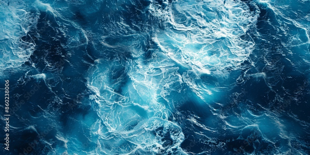 A spectacular aerial top view photo captures the backdrop of ocean sea water, with white waves splashing in the deep sea. This drone photo provides a bird's-eye view of the dynamic waves A spectacular aerial top view photo captures the backdrop of ocean sea water, with white waves splashing in the deep sea. This drone photo provides a bird's-eye view of the dynamic waves