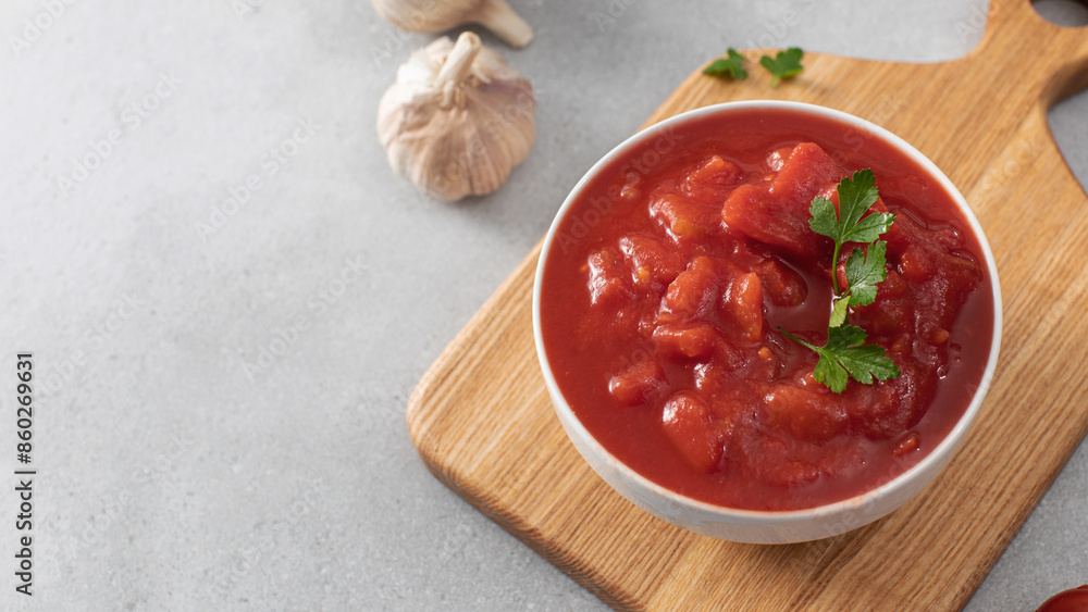 Canned whole peeled tomatoes with juice and parsley on table. Copy space Canned whole peeled tomatoes with juice and parsley on table. Copy space