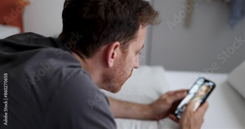 Man Scrolling on Social Media. man casually scrolling through social media on his smartphone. contemporary habits. addicted to fake news and scrolling on social platforms. wasting time. screen time.