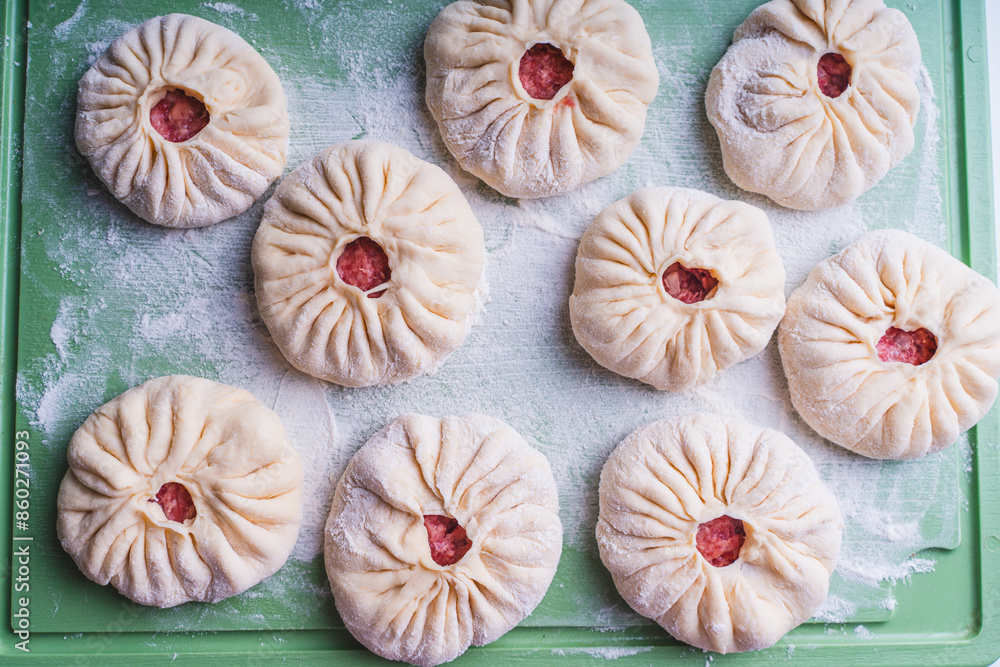 Homemade meat, open pies or belyashi - a traditional Tatar dish before frying Homemade meat, open pies or belyashi - a traditional Tatar dish before frying