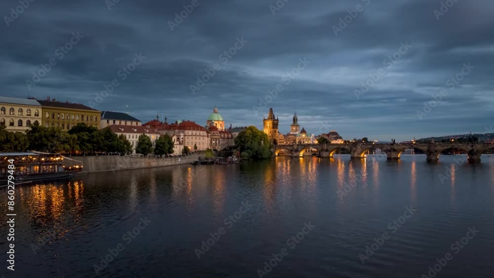 Evening motion time lapse view of the cityscape of Prague with Charles Bridge, river Vltava and boat traffic, Czech Republic Evening motion time lapse view of the cityscape of Prague with Charles Bridge, river Vltava and boat traffic, Czech Republic