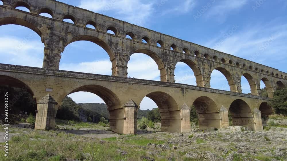 Ancient Roman aqueduct, Pont du Gard, under a clear blue sky in picturesque Provence, near Nimes city in France Ancient Roman aqueduct, Pont du Gard, under a clear blue sky in picturesque Provence, near Nimes city in France
