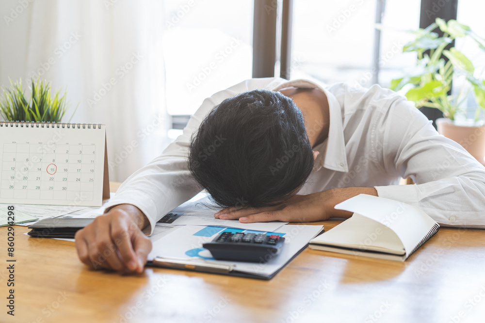 Financial concept, owe asian young male sitting suffer, stressed and confused by calculate expense from invoice, credit card, no money to pay mortgage or loan. Debt, bankrupt people. Financial concept, owe asian young male sitting suffer, stressed and confused by calculate expense from invoice, credit card, no money to pay mortgage or loan. Debt, bankrupt people.