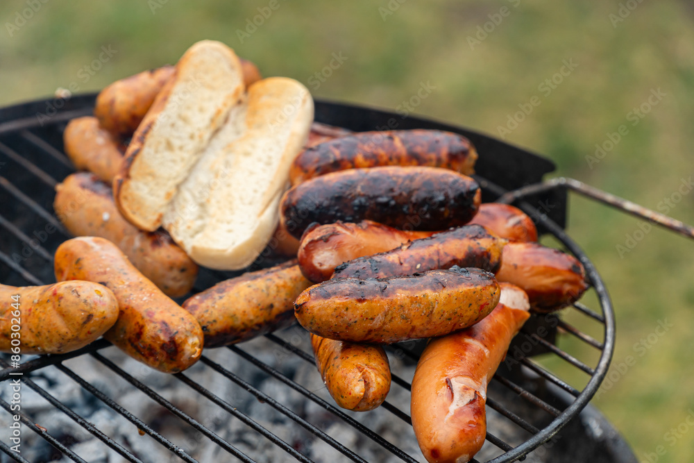 Sausages grilling on an outdoor barbecue Sausages grilling on an outdoor barbecue