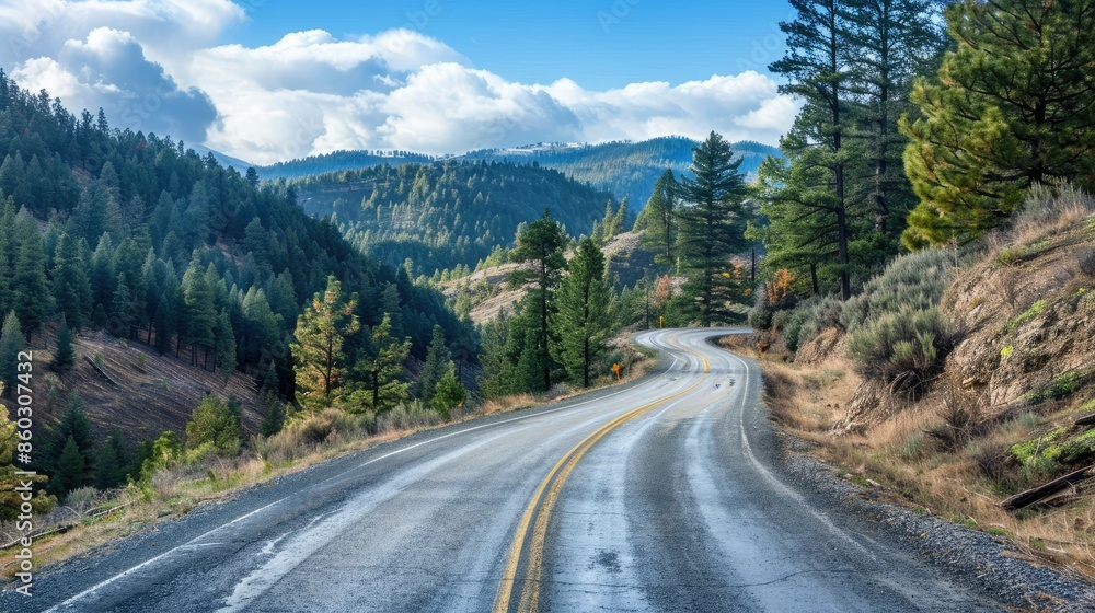 Picturesque asphalt road winding through a forested mountain landscape Picturesque asphalt road winding through a forested mountain landscape