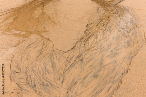 Spring runoff flows over the beach sand at Harrington Beach State Park, Belgium, Wisconsin, creating an abstract image in mid-March photo