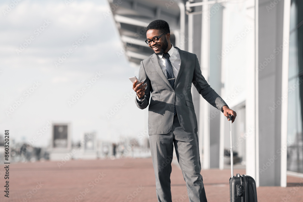 Businessman Texting On Phone, Arriving at Airport and Waiting for Taxi Outdoors Businessman Texting On Phone, Arriving at Airport and Waiting for Taxi Outdoors