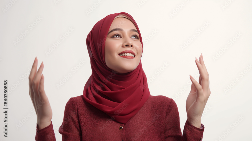Woman in red hijab smiling and looking upwards Woman in red hijab smiling and looking upwards