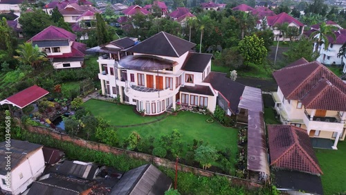 Aerial Shot of Luxurious Mansion Surrounded by Greenery in a Quiet Neighborhood photo