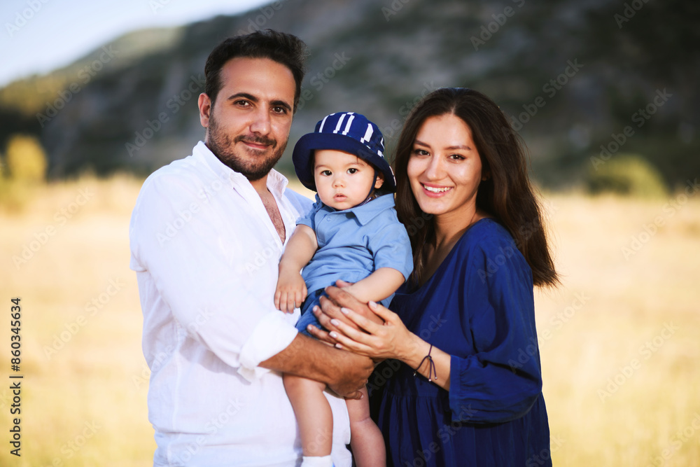 Obraz premium Family Portrait in Nature: Turkish Father, Uzbek Mother, and Child