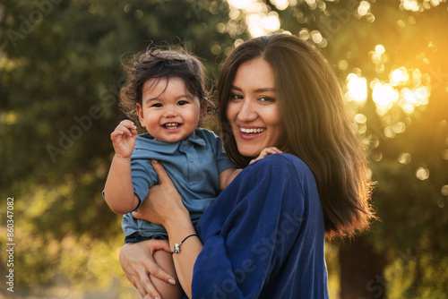 Mother Holding Her One Year Old Son in Nature photo