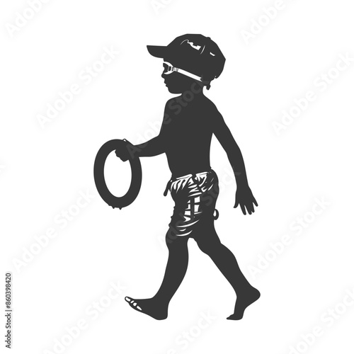 Silhouette of boy with inner tube, swim goggles and cap, walking to the beach.