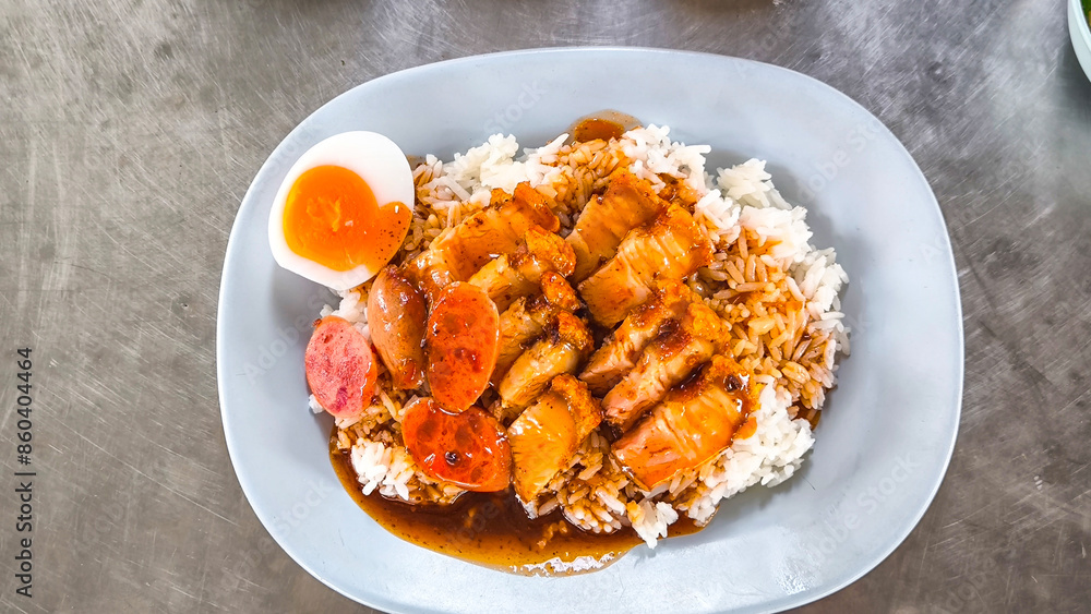 Crispy pork rice on a blue plate on the dining table Crispy pork rice on a blue plate on the dining table