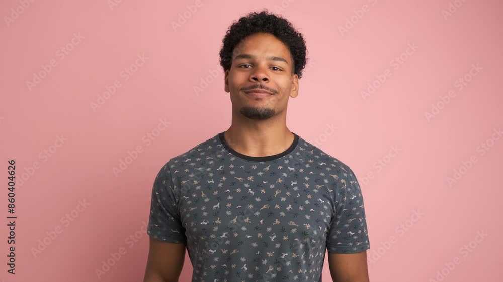 Smiling young man looking at camera in pink studio Smiling young man looking at camera in pink studio