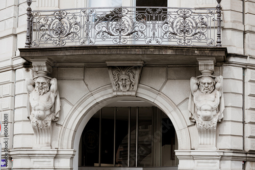 Balcony with atlanteans and mascaron photo