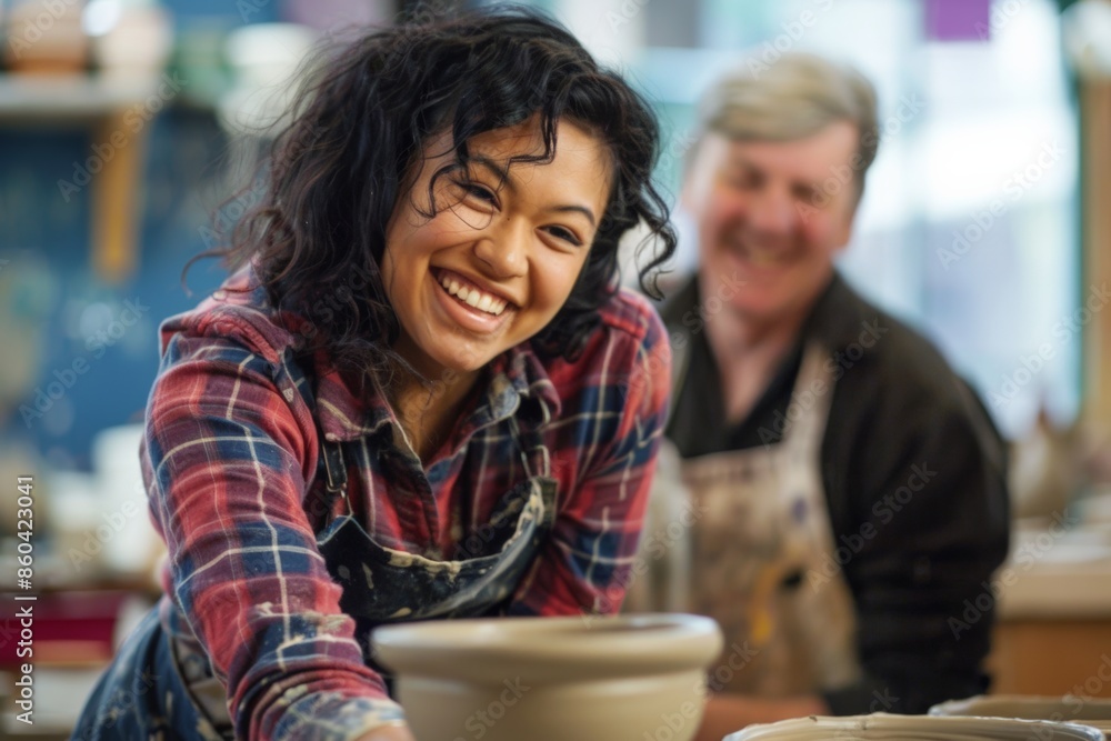 Happy woman making pottery in a studio with a friend. Happy woman making pottery in a studio with a friend.