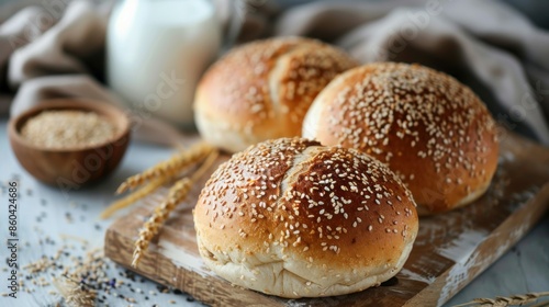 Breakfast with freshly baked round sesame bread and milk