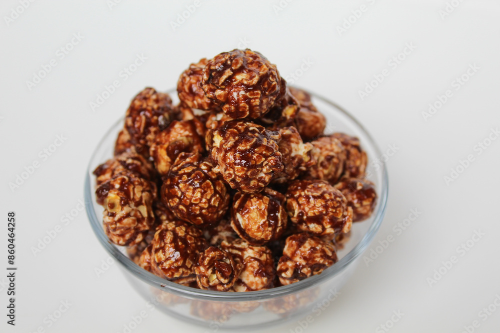 Chocolate popcorn, in transparent glass bowl, isolated on white background Chocolate popcorn, in transparent glass bowl, isolated on white background