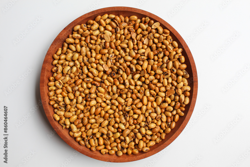 Fried soy bean on wooden plate, isolated on white background, flat lay or top view Fried soy bean on wooden plate, isolated on white background, flat lay or top view
