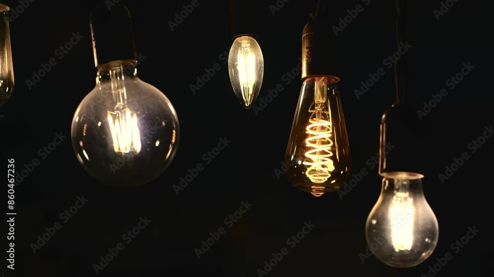 Retro light bulbs hanging on a dark background. Electricity, Vintage Retro light bulbs hanging on a dark background. Electricity, Vintage